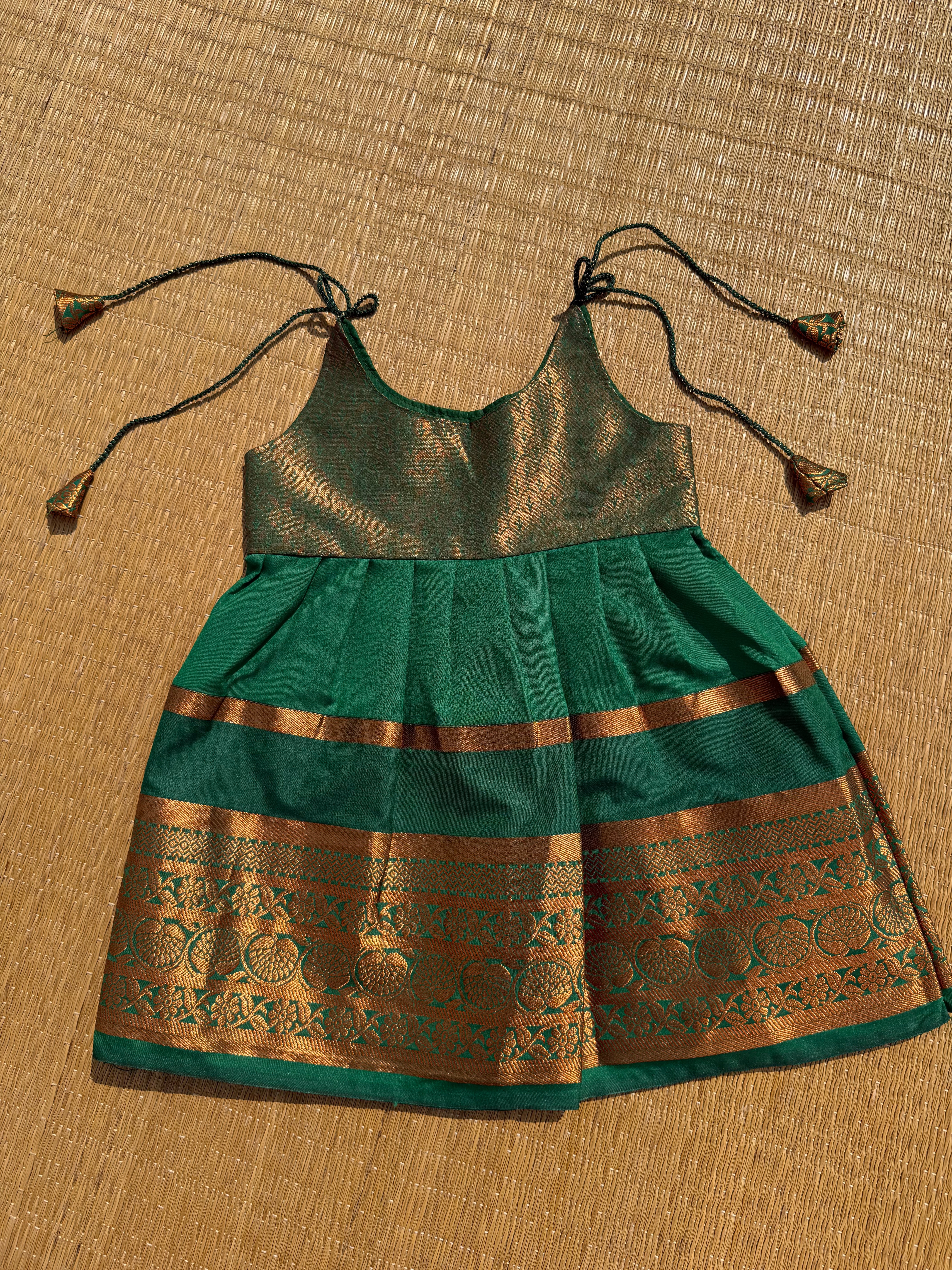 Little Dhiya - Dark green copper zari tie knot frock for babies