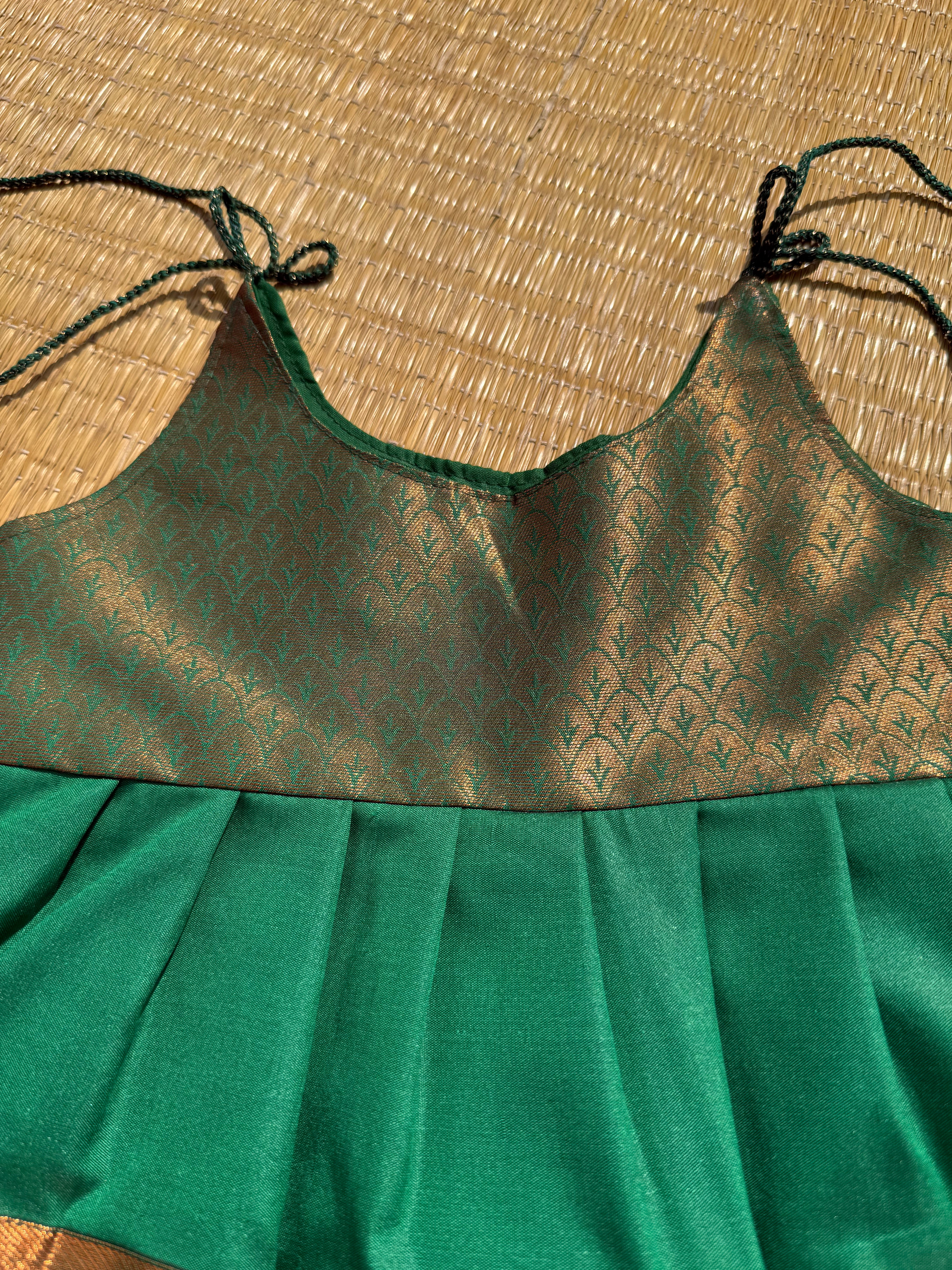 Little Dhiya - Dark green copper zari tie knot frock for babies