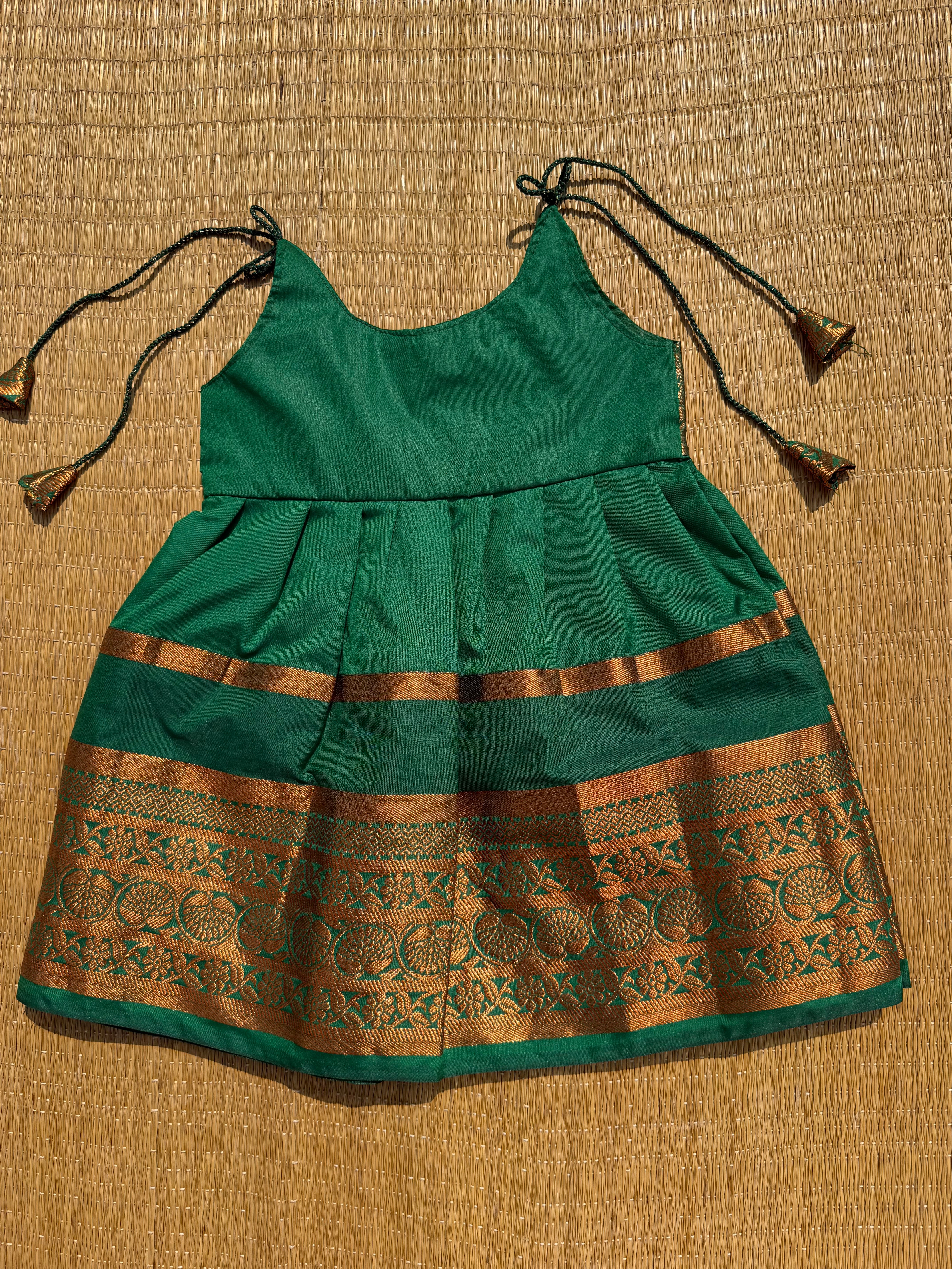 Little Dhiya - Dark green copper zari tie knot frock for babies